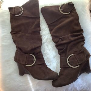 Women’s brown suede wedge heel boots.